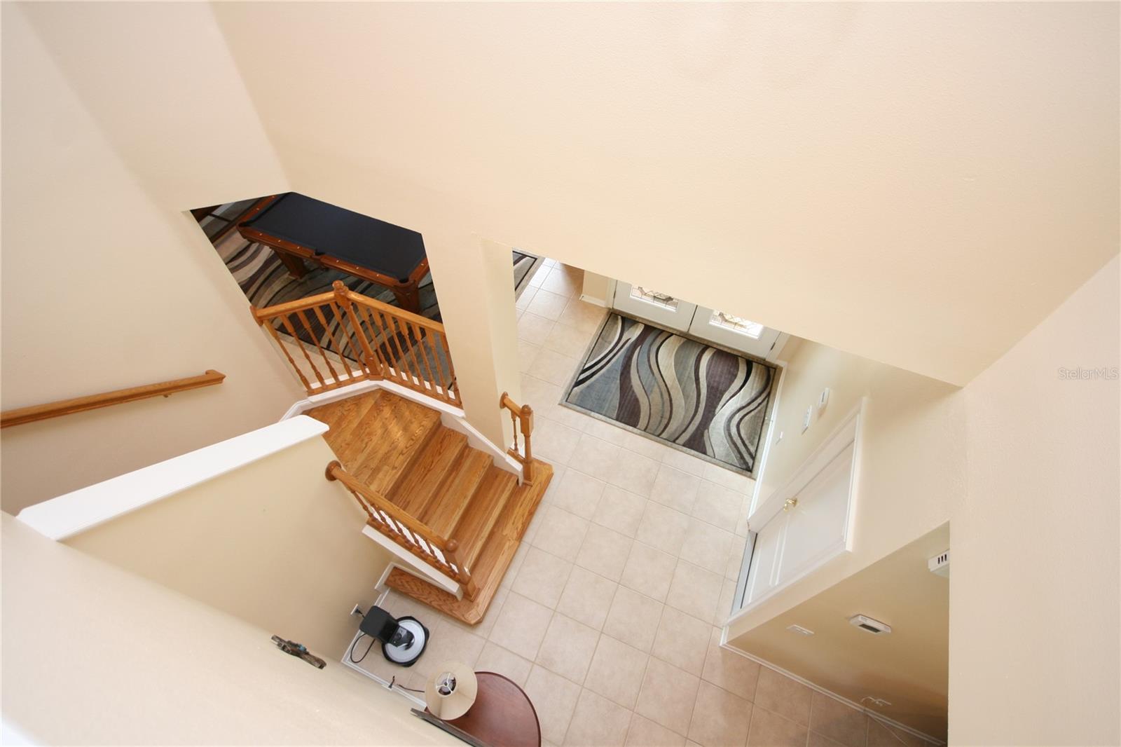 rounded stairwell with view of front door