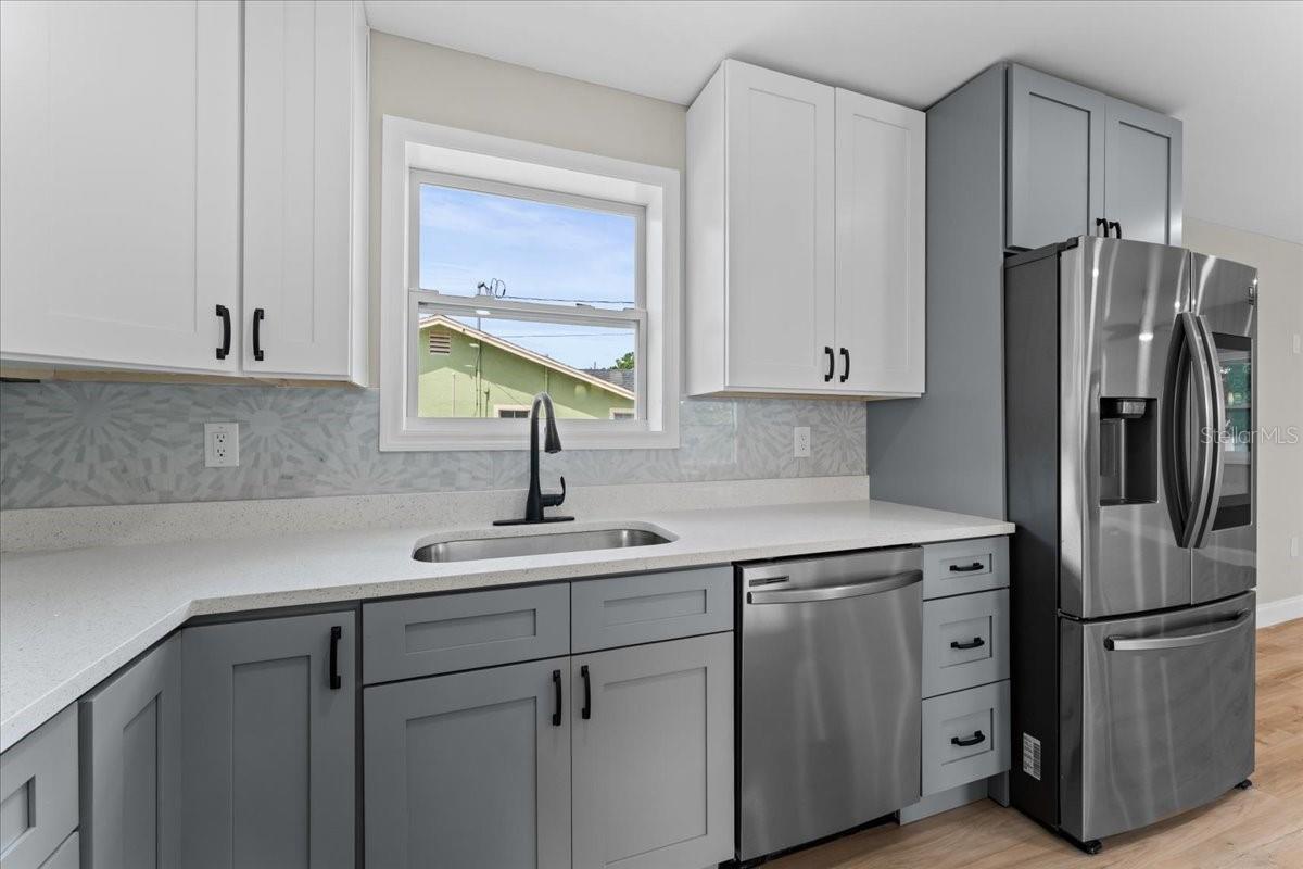 Kitchen sink, dishwasher and fridge