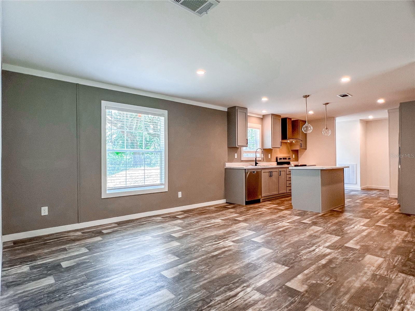 Large dining room leading to the modern kitchen.