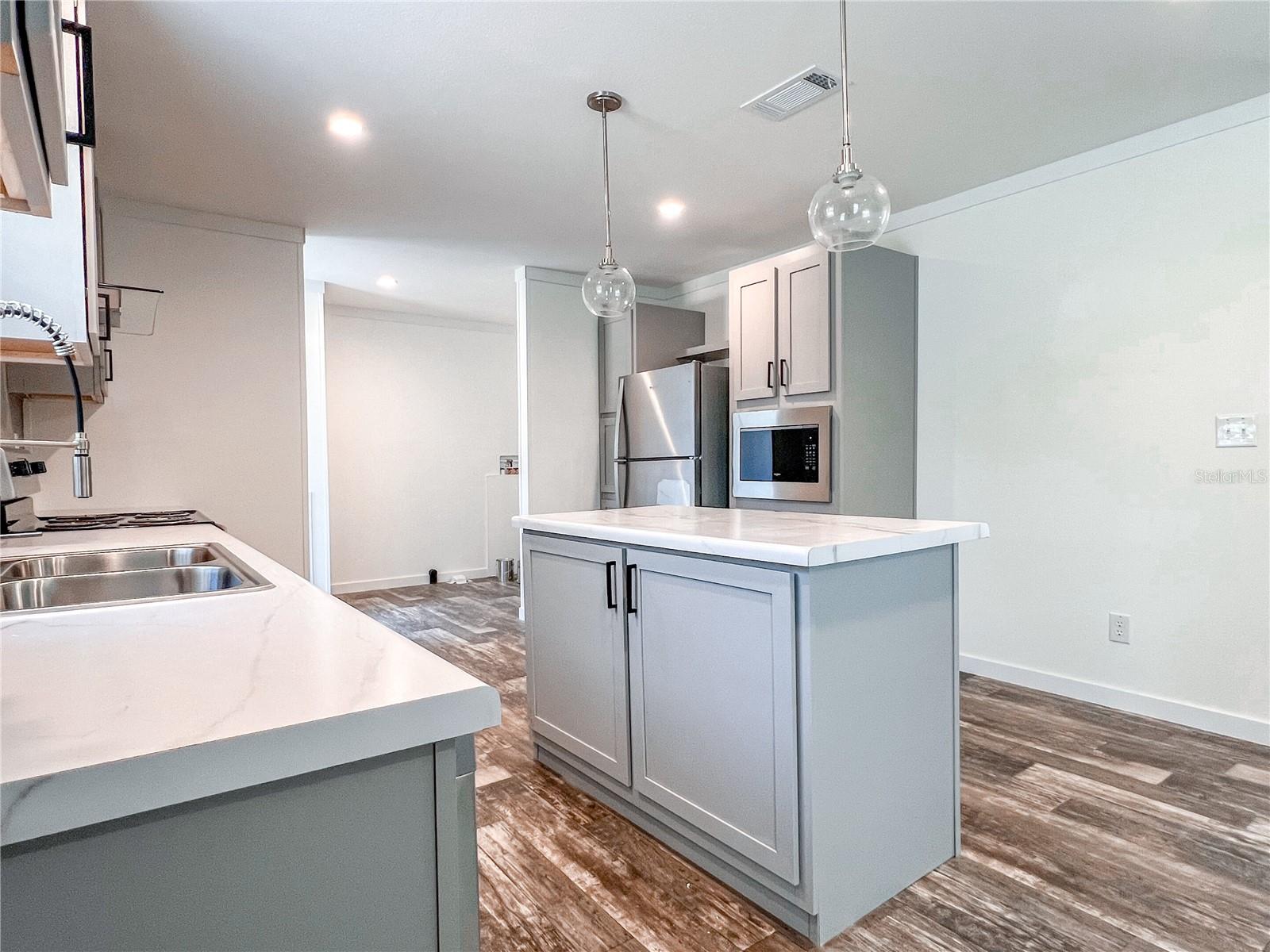 Spacious kitchen with room for a baker's rack.