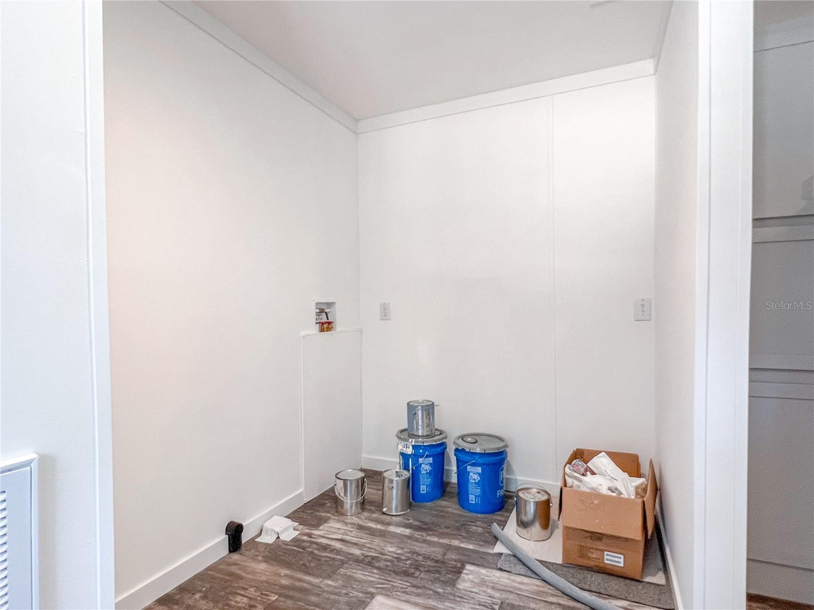 Laundry room off the kitchen and leading to the backyard.