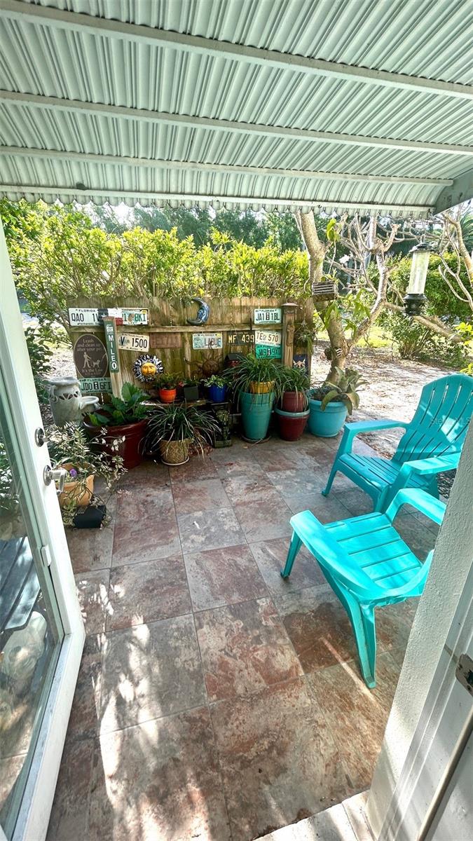 Back porch with plants and awning for shade