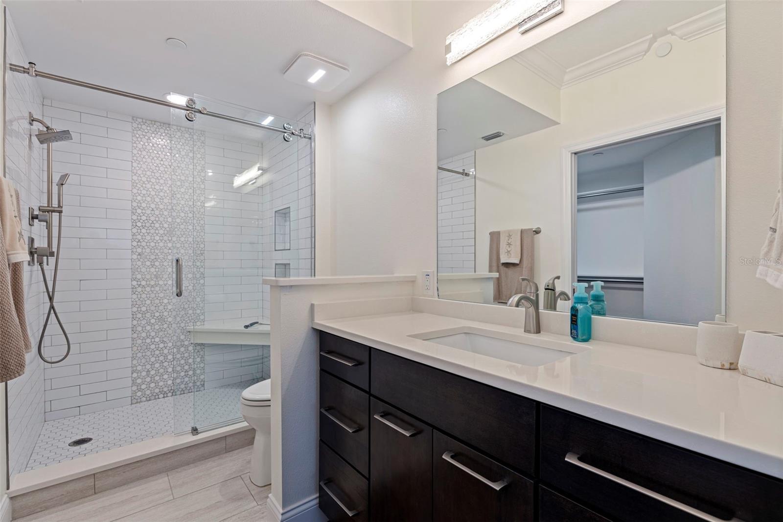 Primary Bath with Kraftmaid Vanity, Custom Tile Shower with Glass Doors
