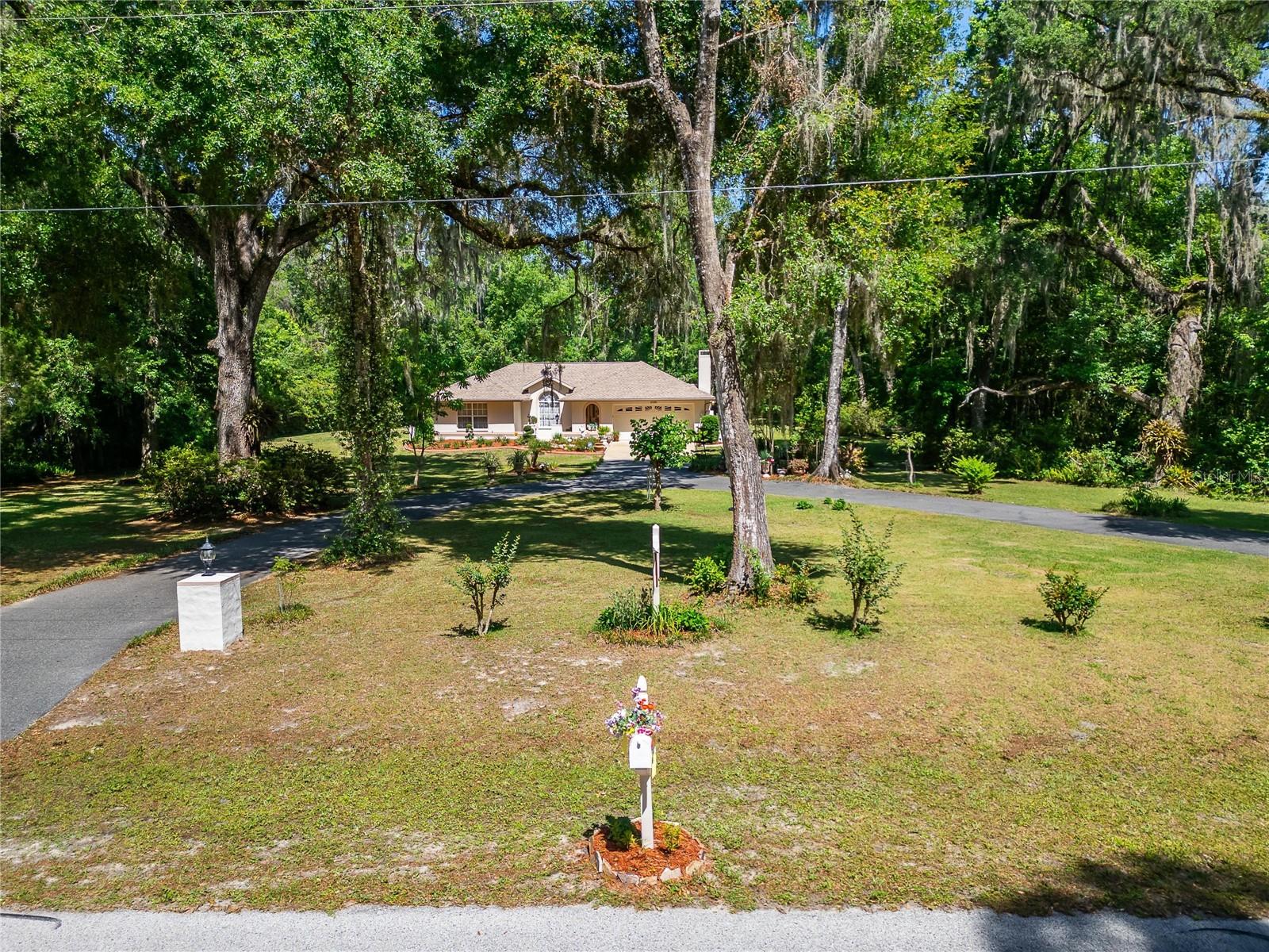 2.5 acres with paved circular driveway with lighted entrance posts