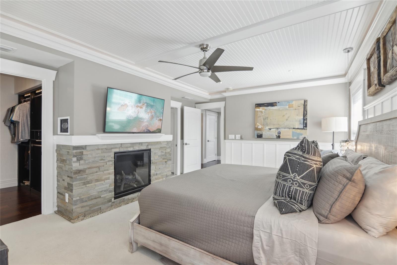 The door to the left leads to the walk-in closet with custom finishes. The primary bedroom includes a working fireplace.