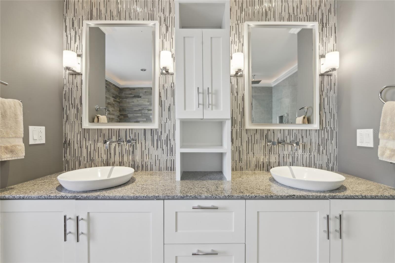 Double-sink vanity offers space for shared use. There is plenty of under-sink storage.