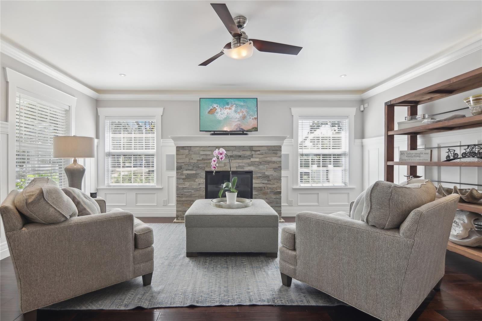 Bright and welcoming living room with a fireplace, located just off the entry.
