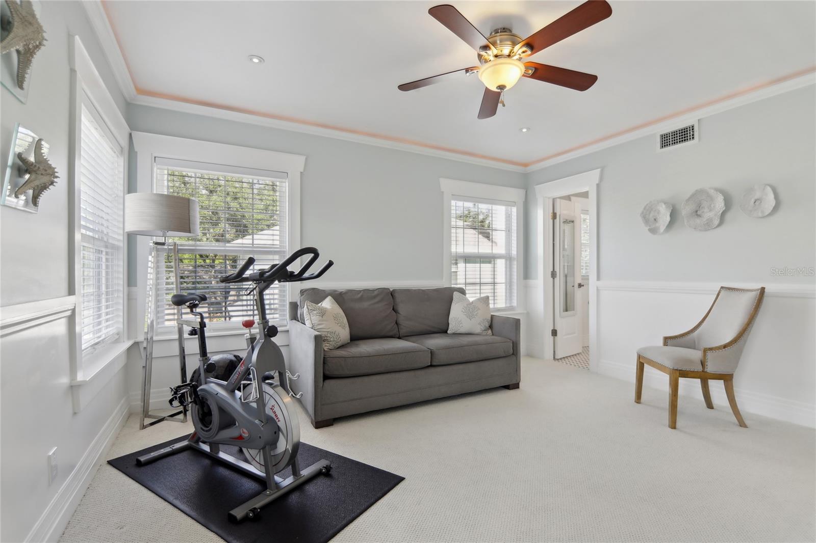 Each upstairs bedroom includes a ceiling fan. This room is currently used as a home gym.