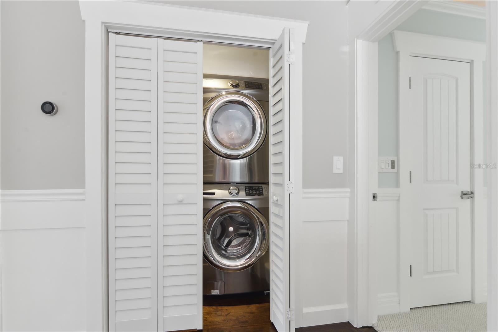 The laundry room is located upstairs off the hall landing, offering added convenience.