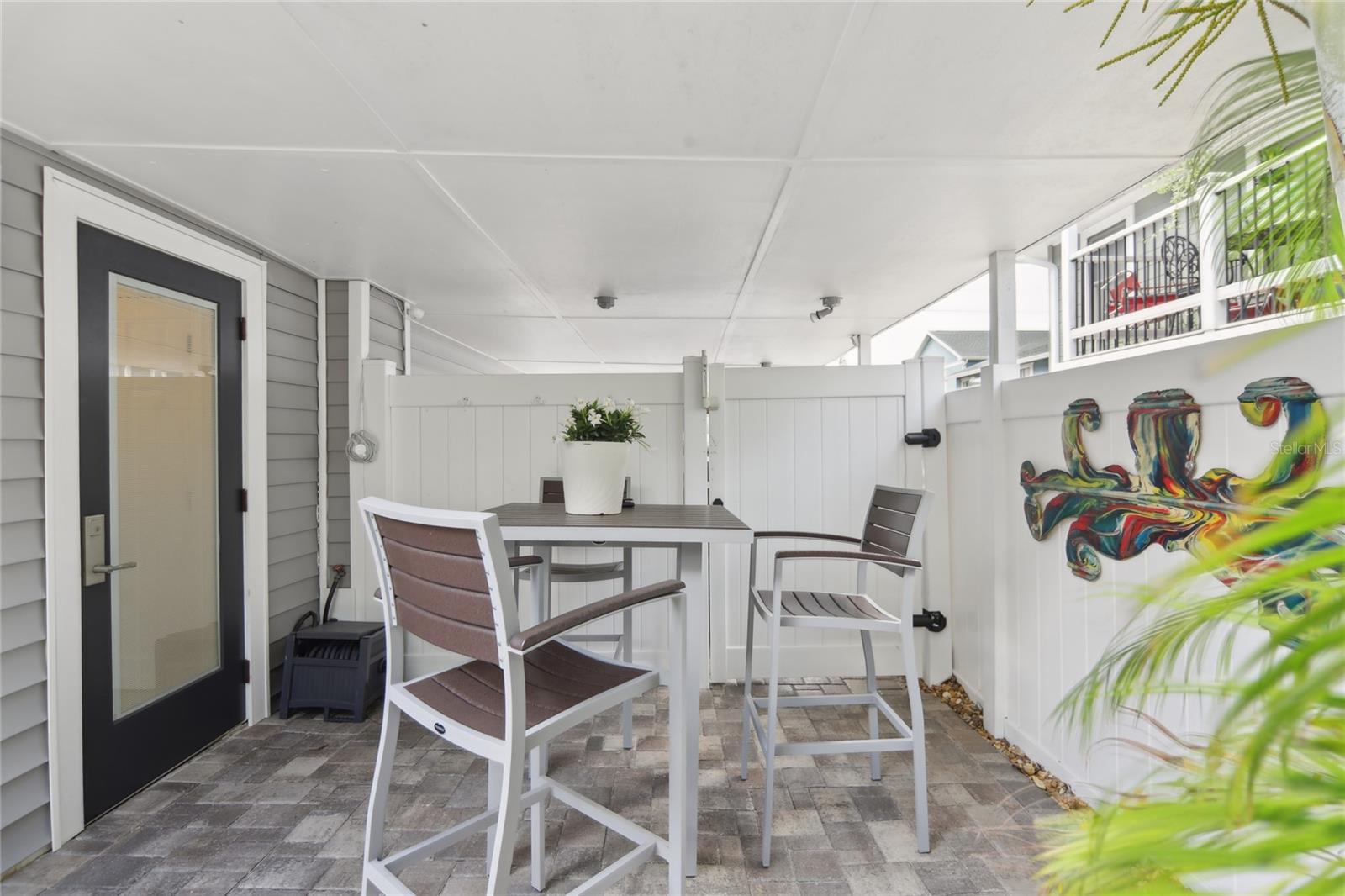 Additional covered area on the pool deck. The pool bathroom is located to the left.
