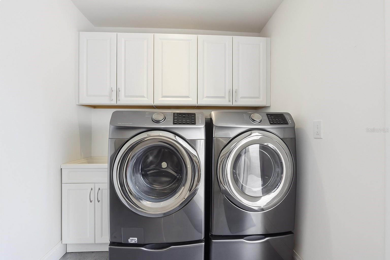 Laundry room under the ADU offers convenient access for guests and ADU use.