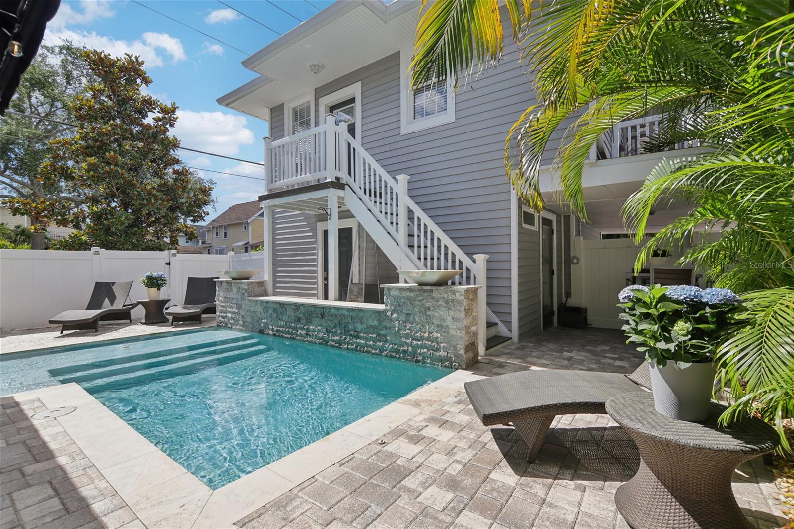 Exterior stairs provide access to the upstairs ADU.