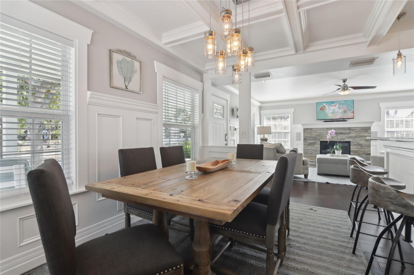 Inside, the layout provides a seamless flow between the living, dining, and kitchen areas.