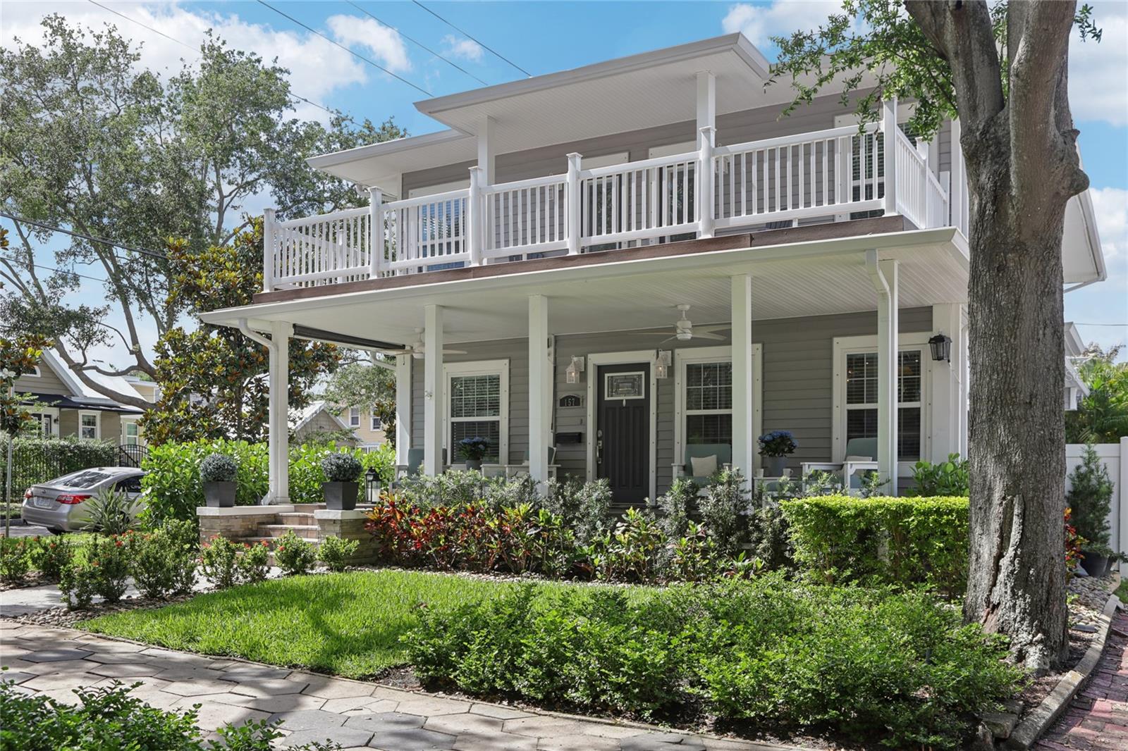 Welcoming front porch surrounded by mature trees. Large upstairs terrace