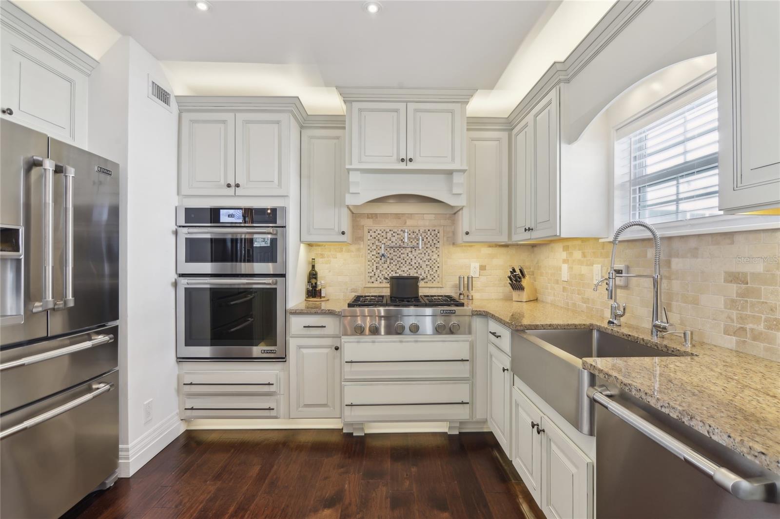 Kitchen features Jenn-Air professional-grade appliances and a gas cooktop.