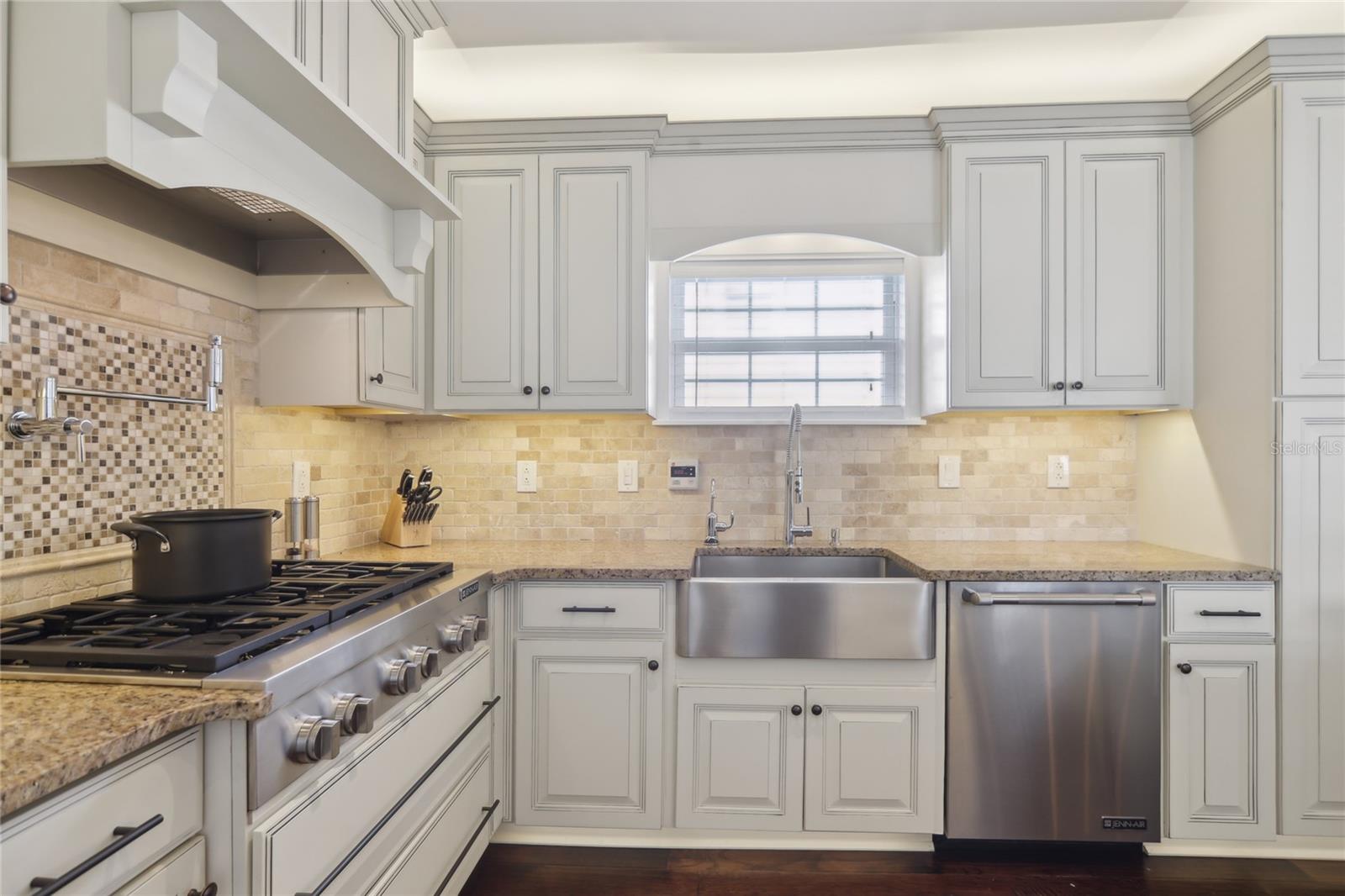 Equipped with a natural gas range from city gas, pot filler, and farmhouse sink.