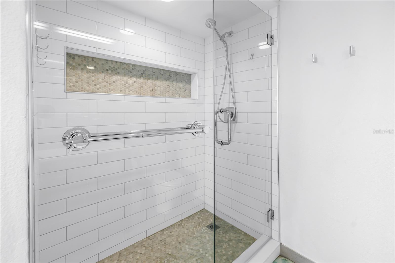 New tile shower with large niche.