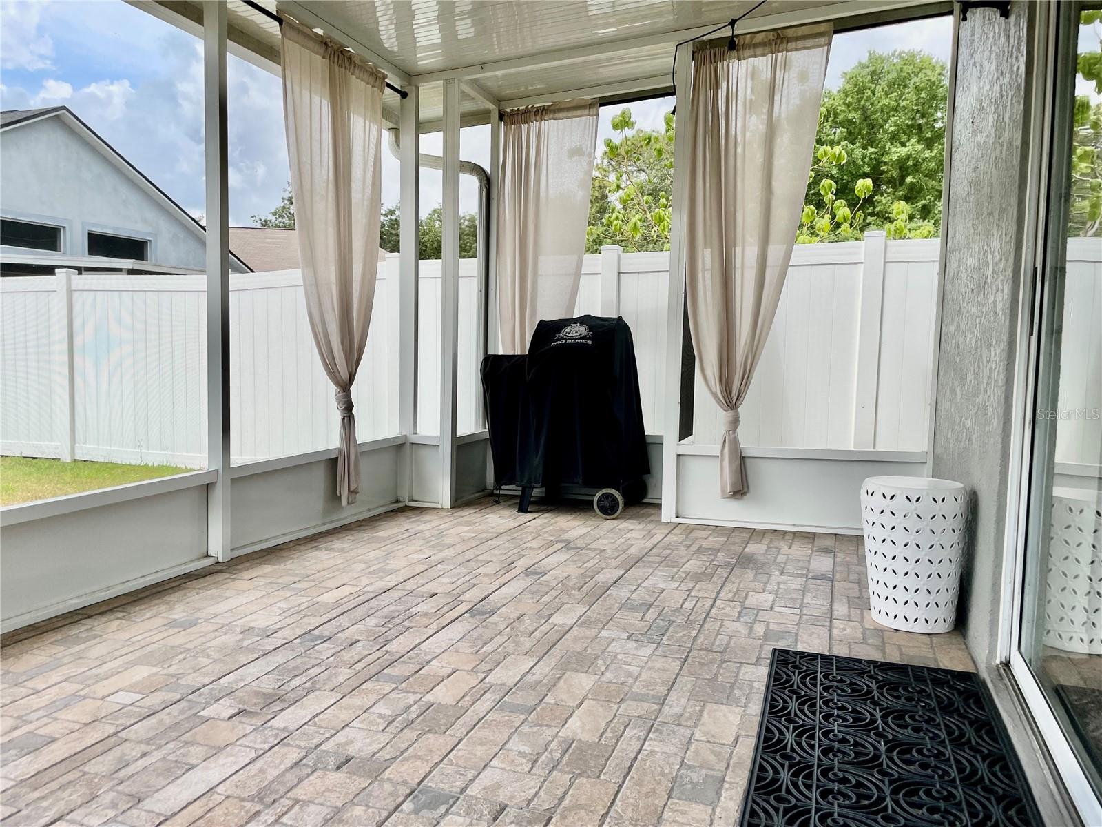 Paver tiled extended screened in covered Lanai