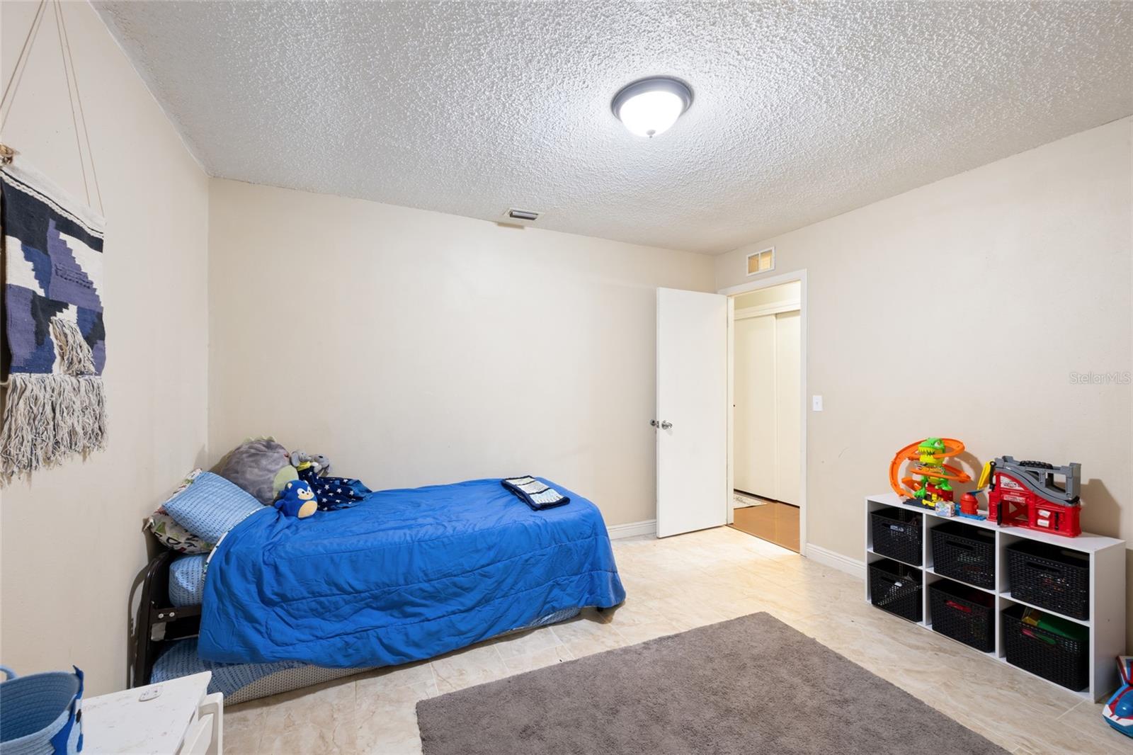 Bedroom 4 with separate backyard entrance & view of lake