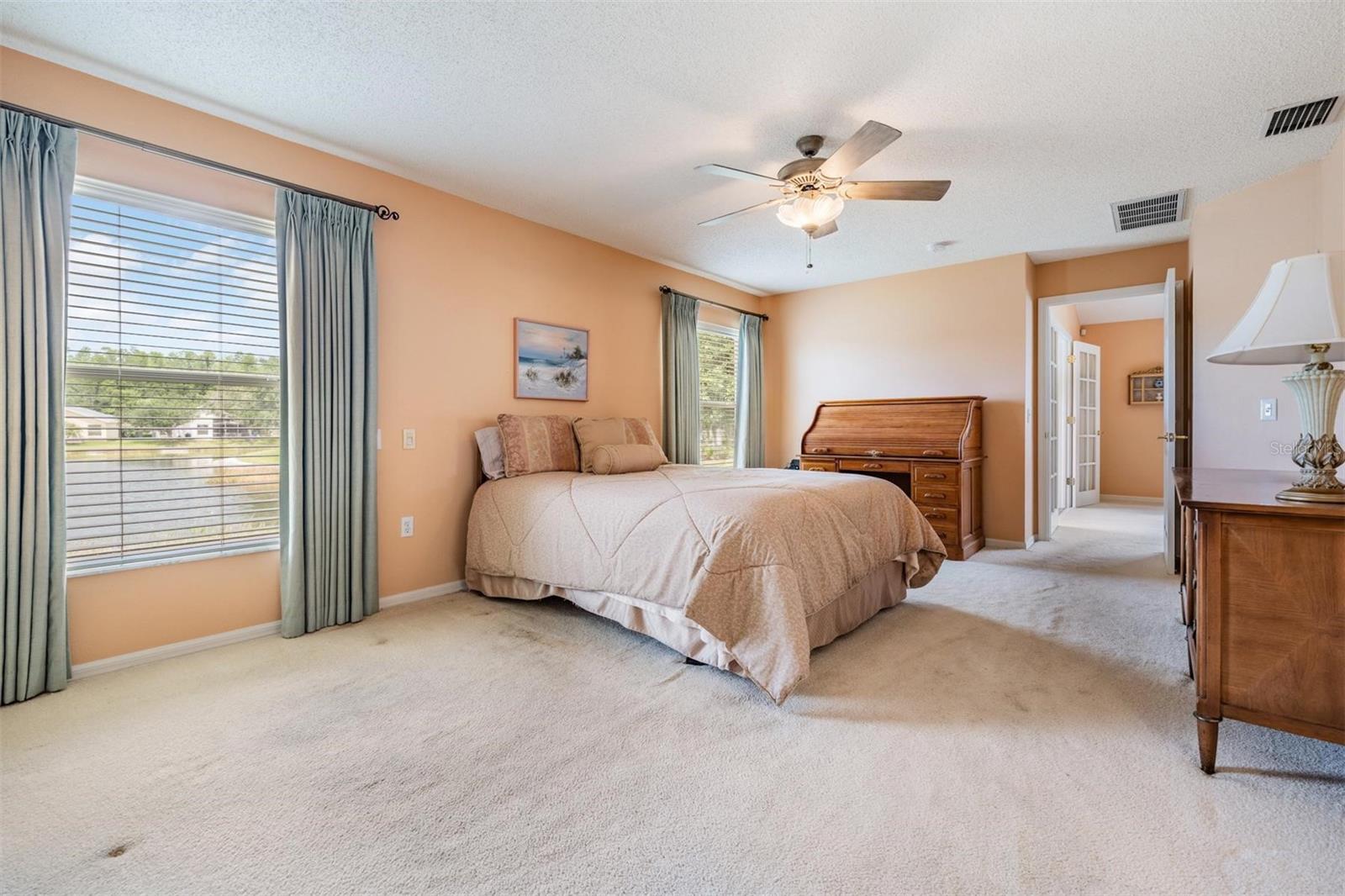 Oversized primary bedroom with pond views