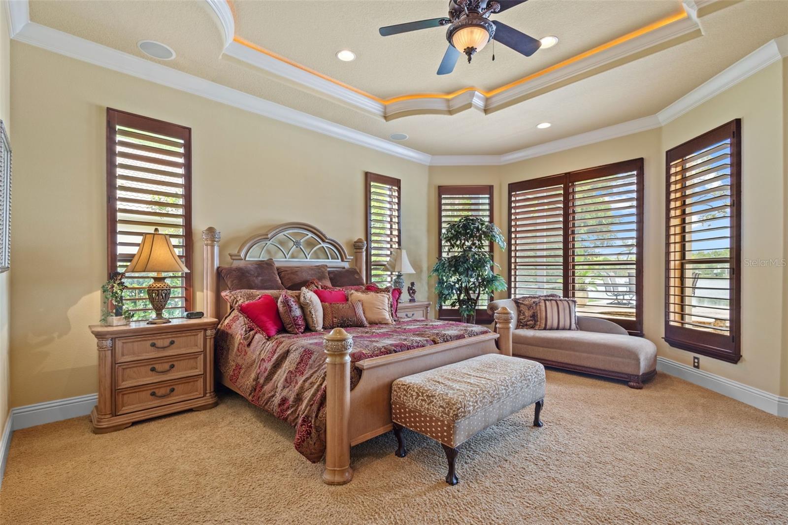 Main floor primary suite with view to pool area.
