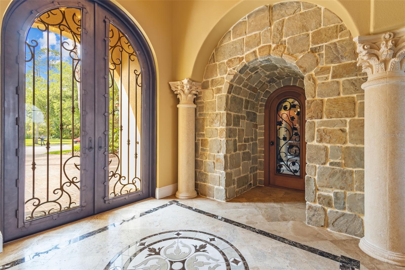 Custom steel and beveled glass main entry door and wine cellar.