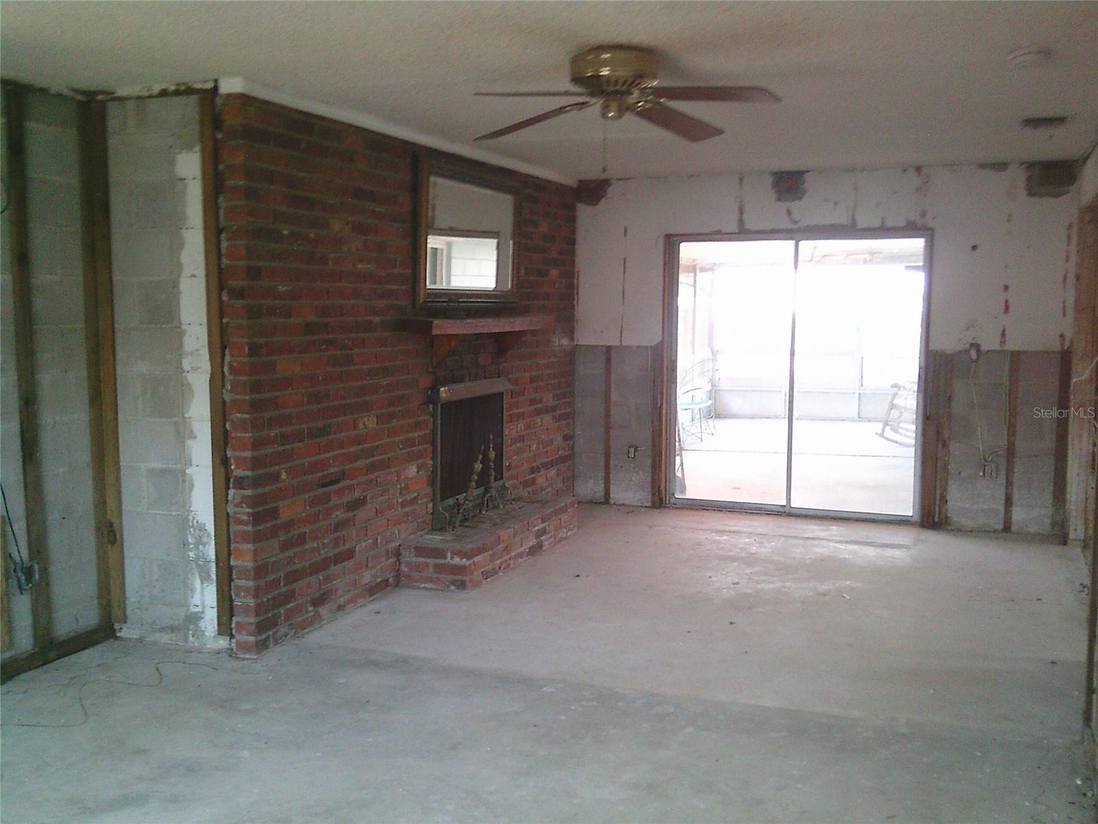 View from family room looking towards fireplace and out the rear sliders
