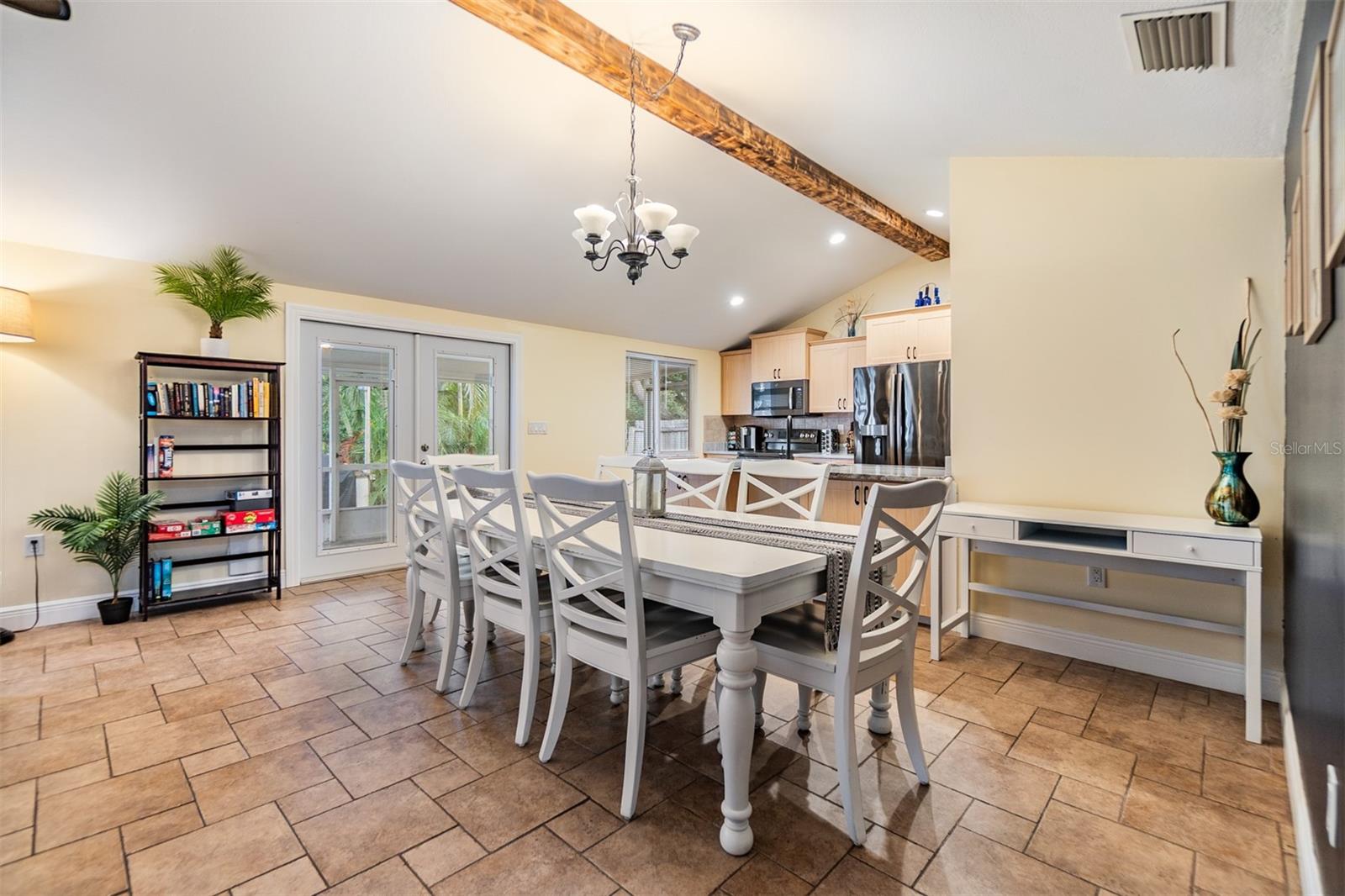 Vaulted Ceilings, Dining Room, and French doors to the outside, tile flooring.