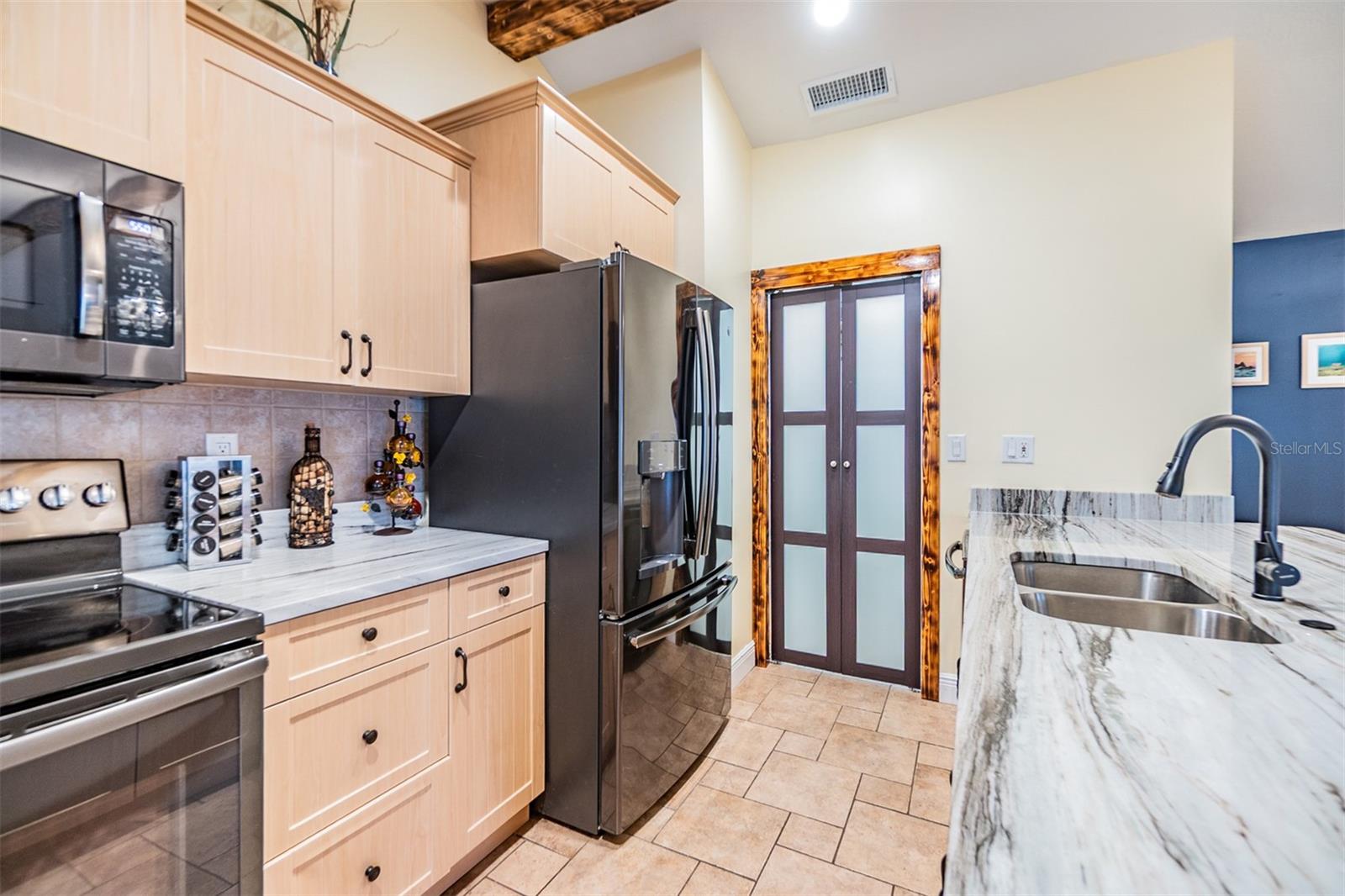Open Kitchen, newer cabinets and Quartzite counter tops, tile flooring