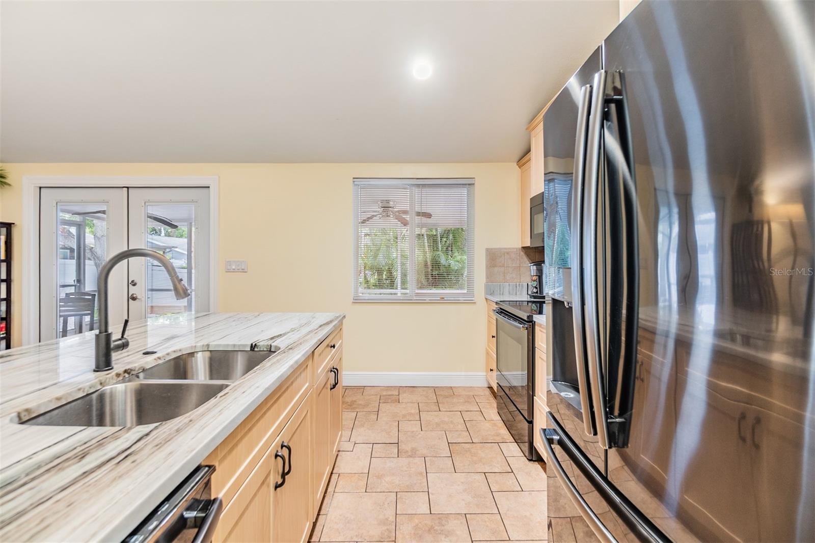 Open Kitchen, newer cabinets and Quartzite counter tops, tile flooring