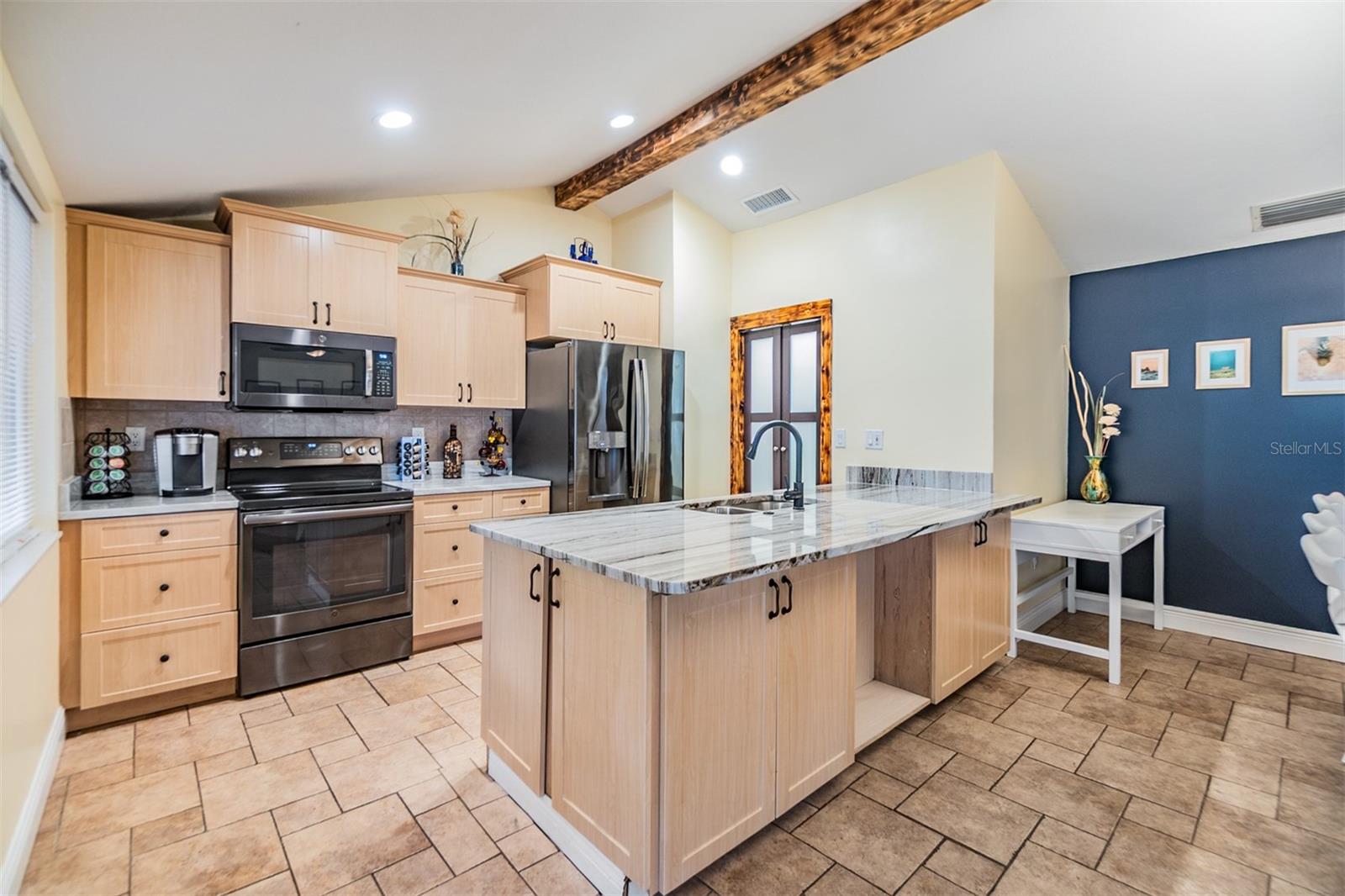 Open Kitchen, newer cabinets and Quartzite counter tops, tile flooring