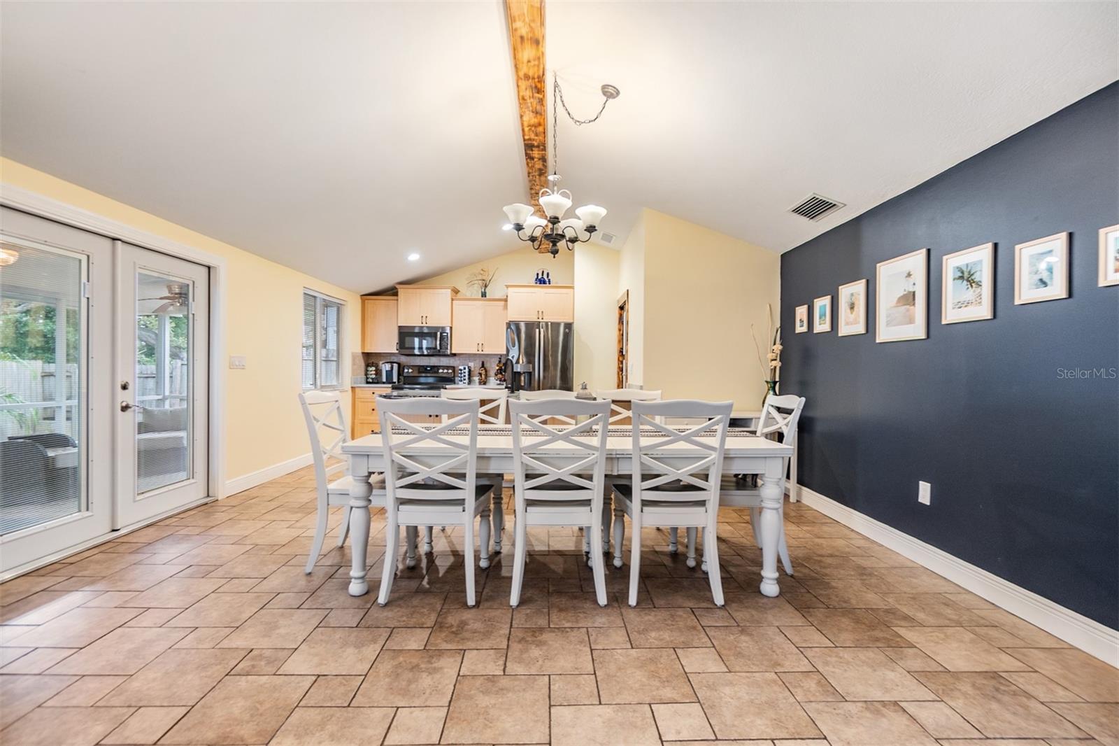Vaulted Ceilings, Dining Room, and French doors to the outside, tile flooring.