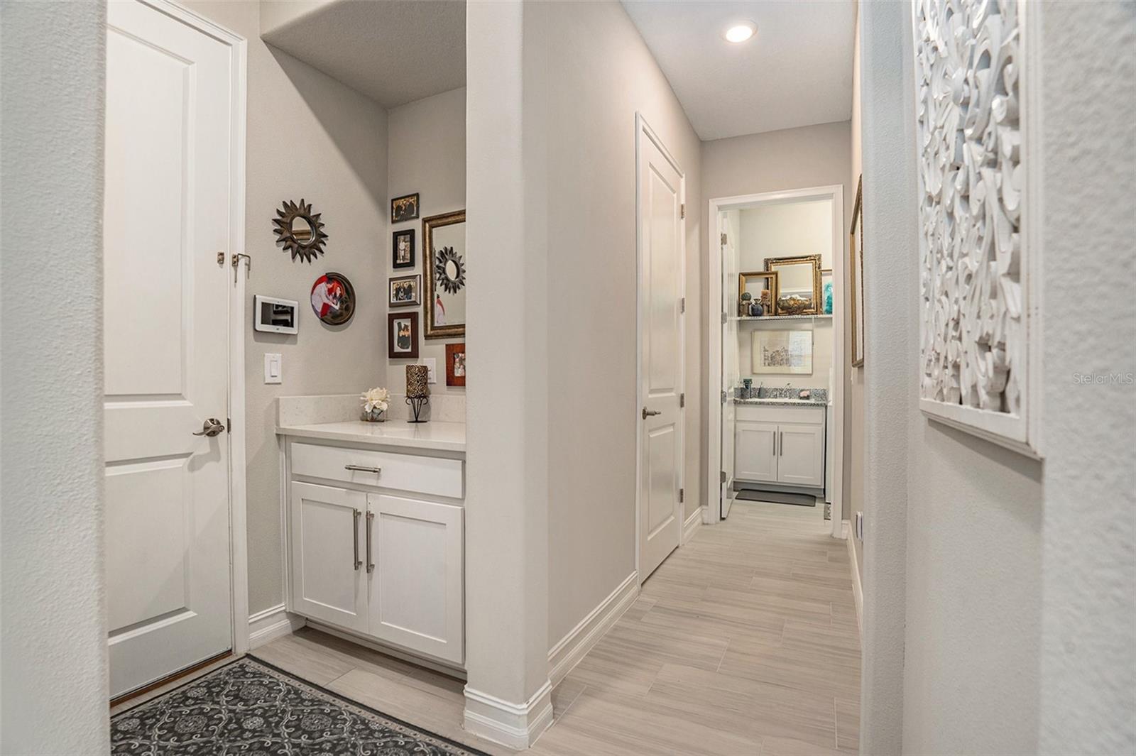 Hall launch leading to garage,powder room and laundry room