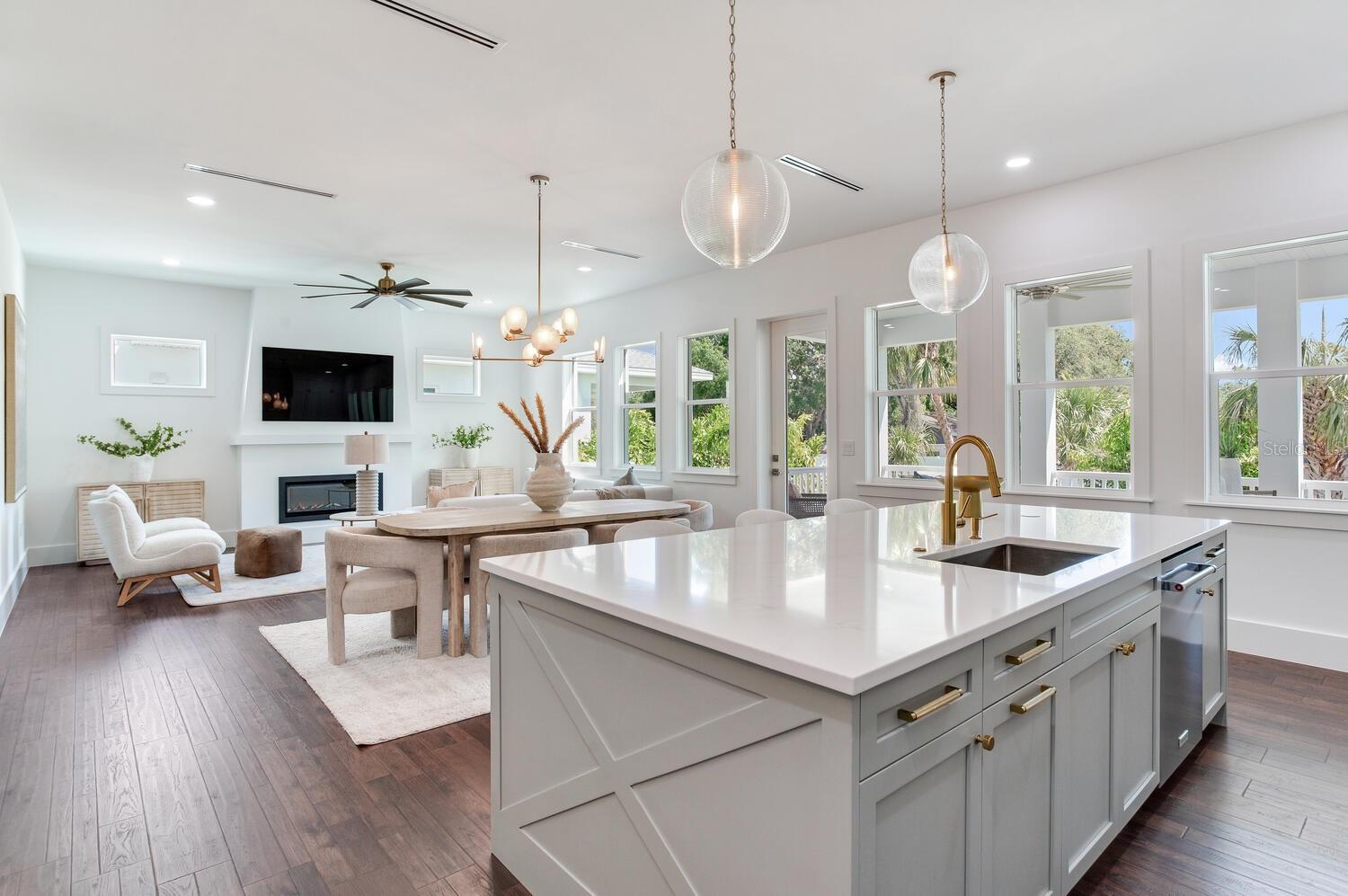 beautiful hard flooring seamlessly connects the living spaces.  Natural lights flows through the hurricane windows