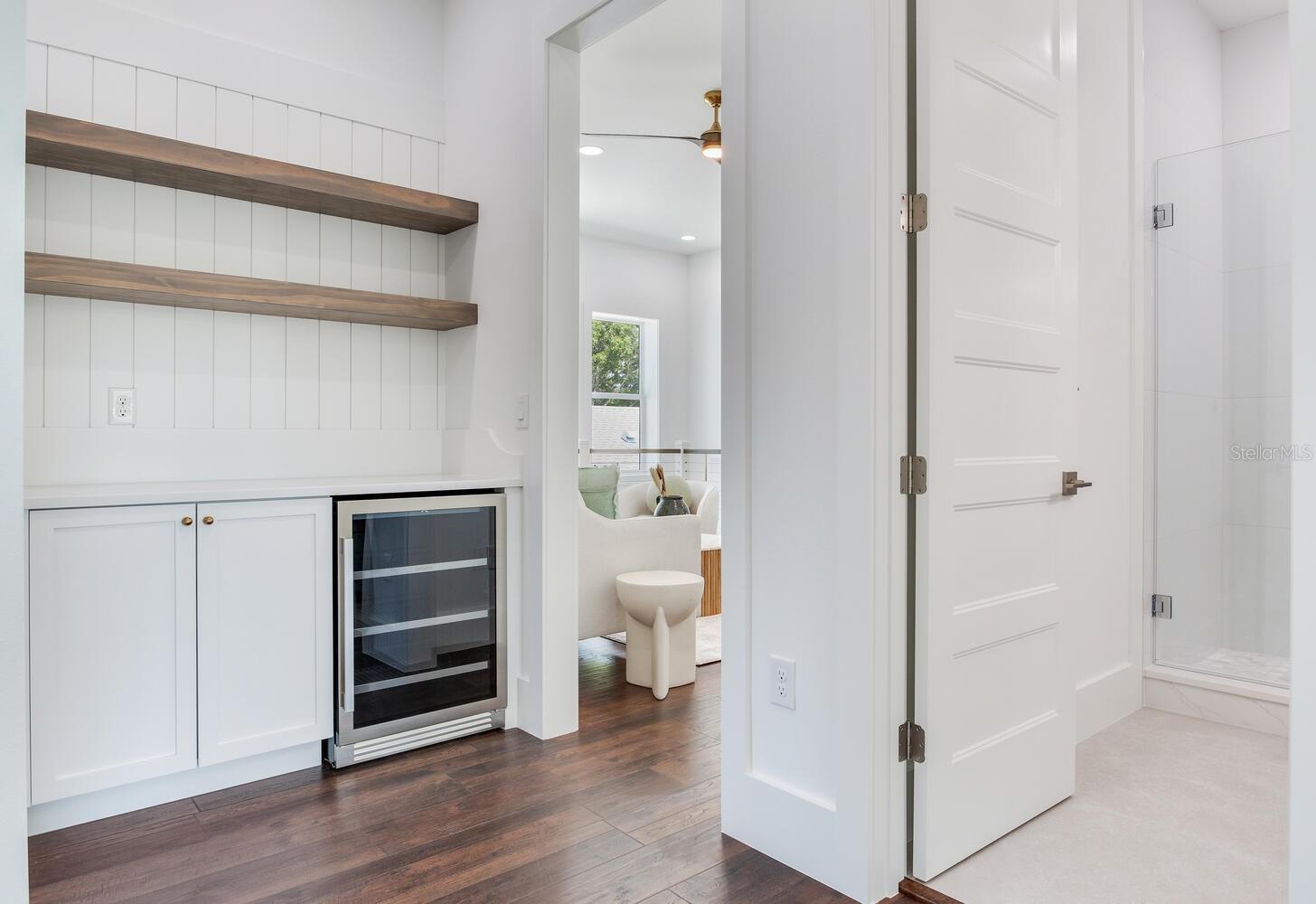 A beverage area and under counter fridge is located just off the loft area.