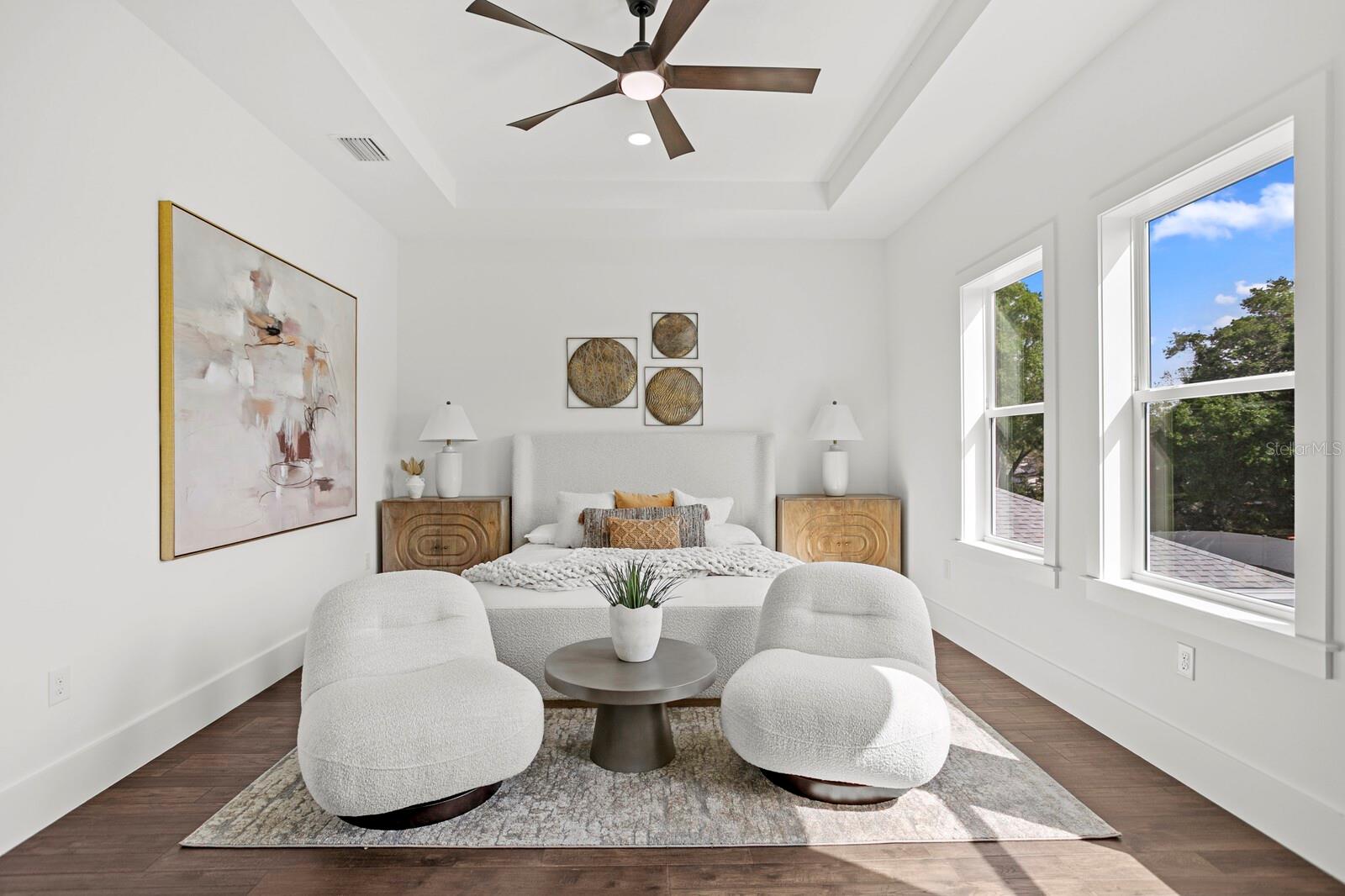 The primary bedroom filled with natural light and classic coastal architecture