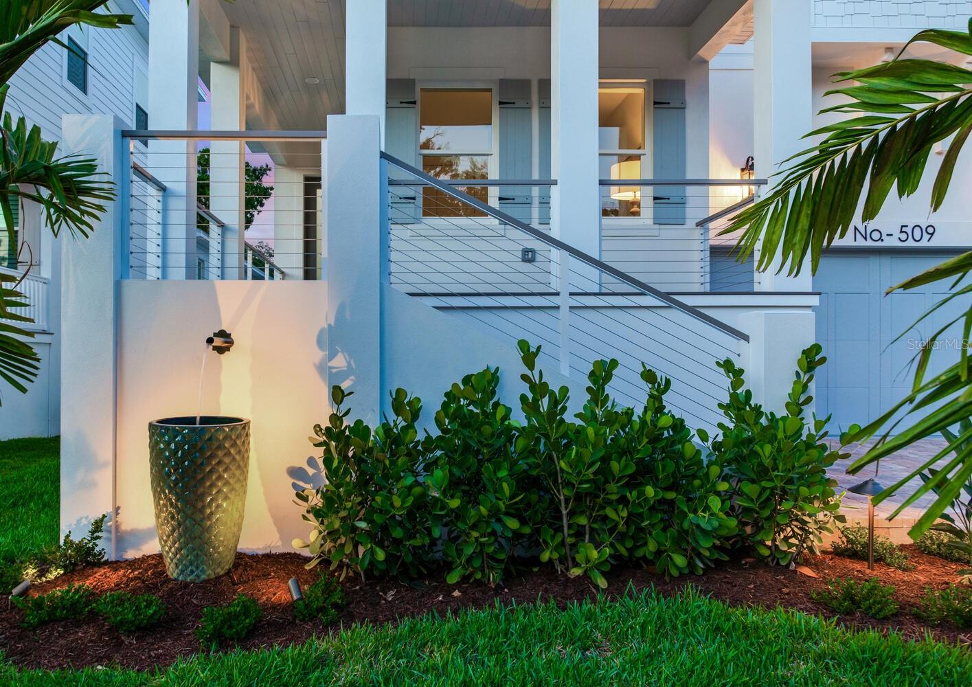 Flowing water feature highlights the front yard area