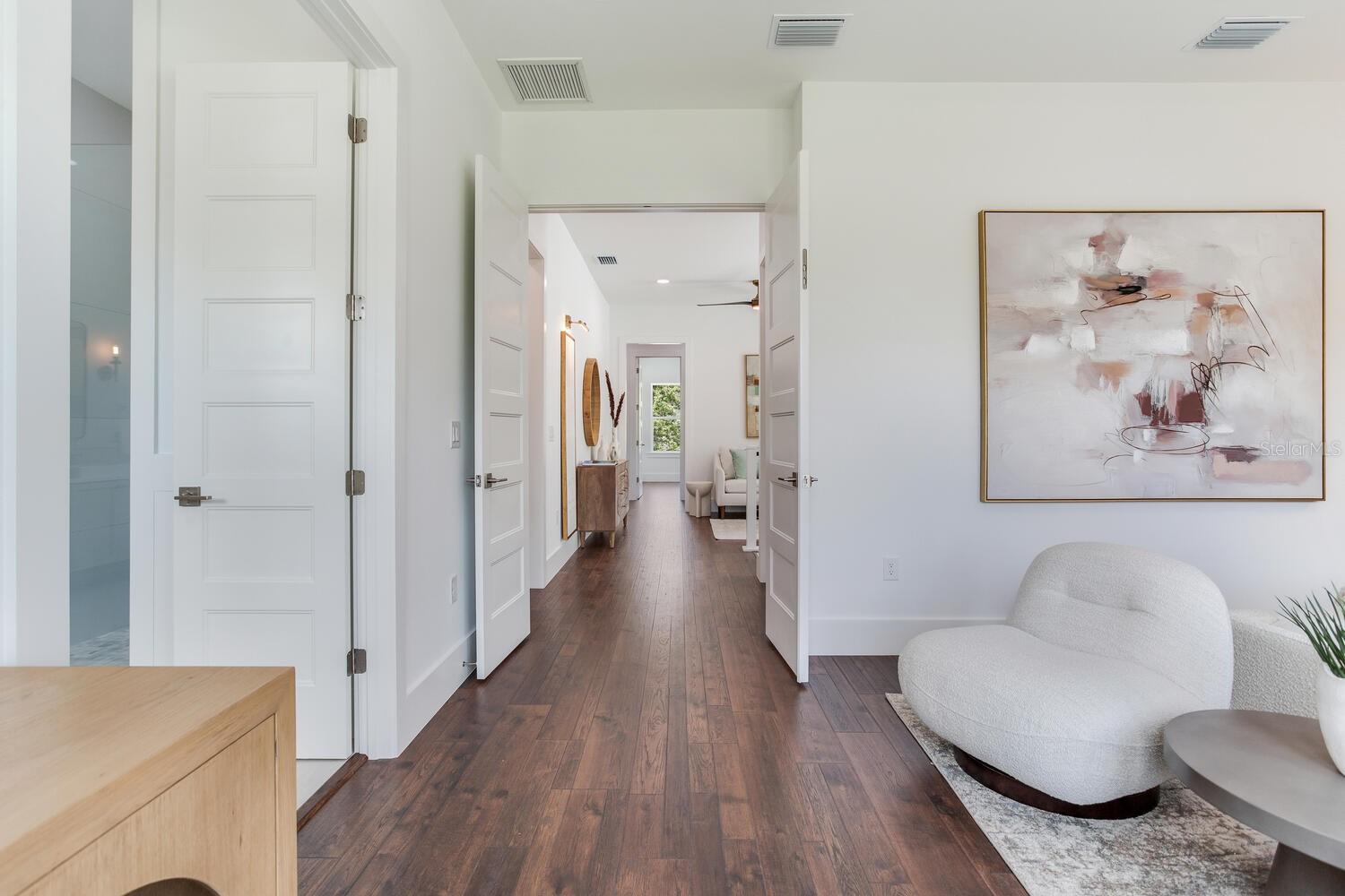 Looking from primary suite to the loft area and bedrooms beyond