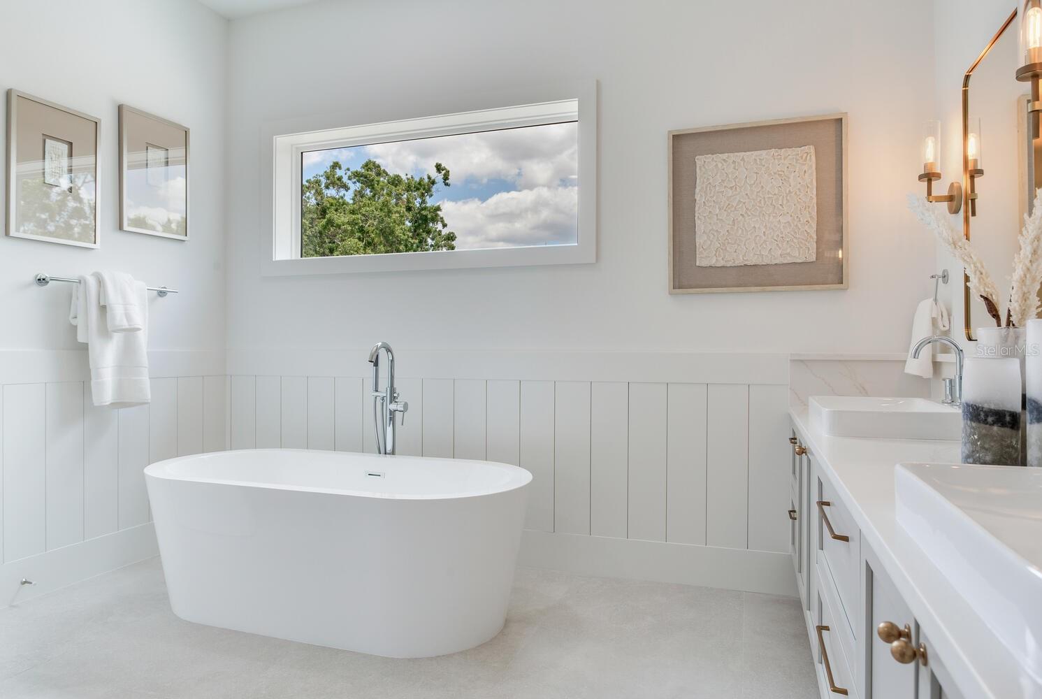 soaker tub is surrounded by vertical shiplap for a beautiful effect