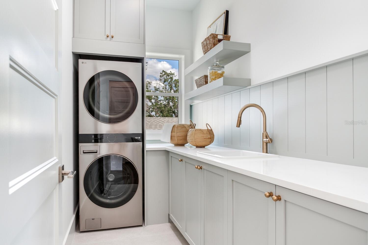 second floor laundry has upgraded stackable washer and dryer and an incredible amount of storage space