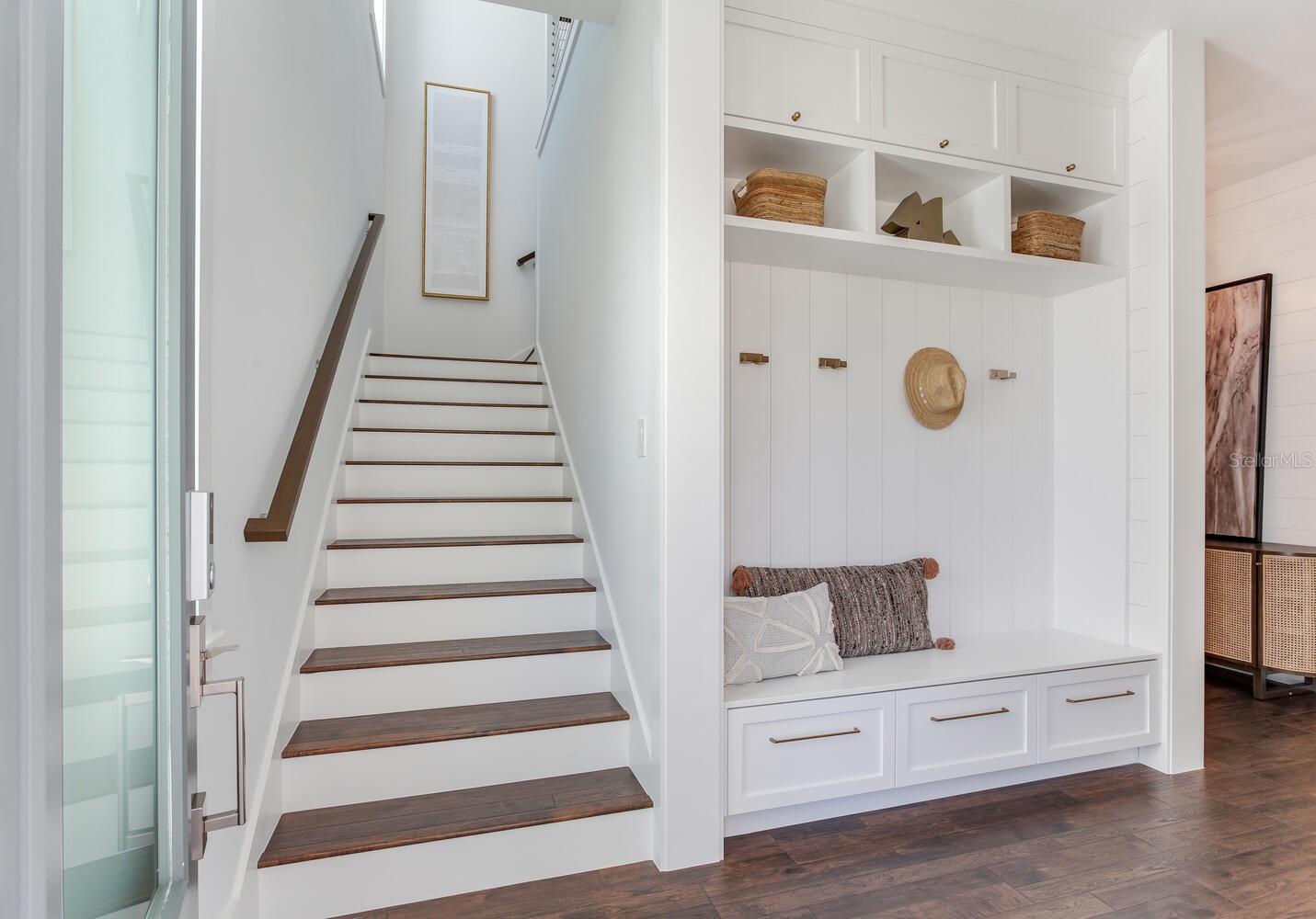 wide staircase and mud room area