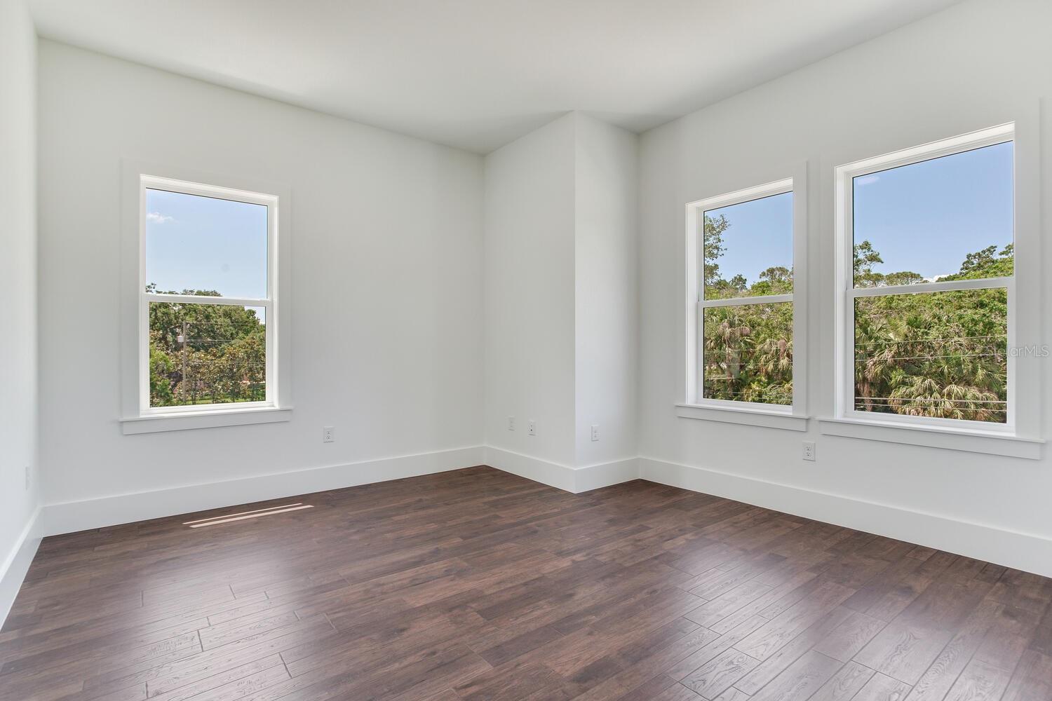 Bedroom 2 on the second floor has unique architecture features as well as 3 windows for natural light