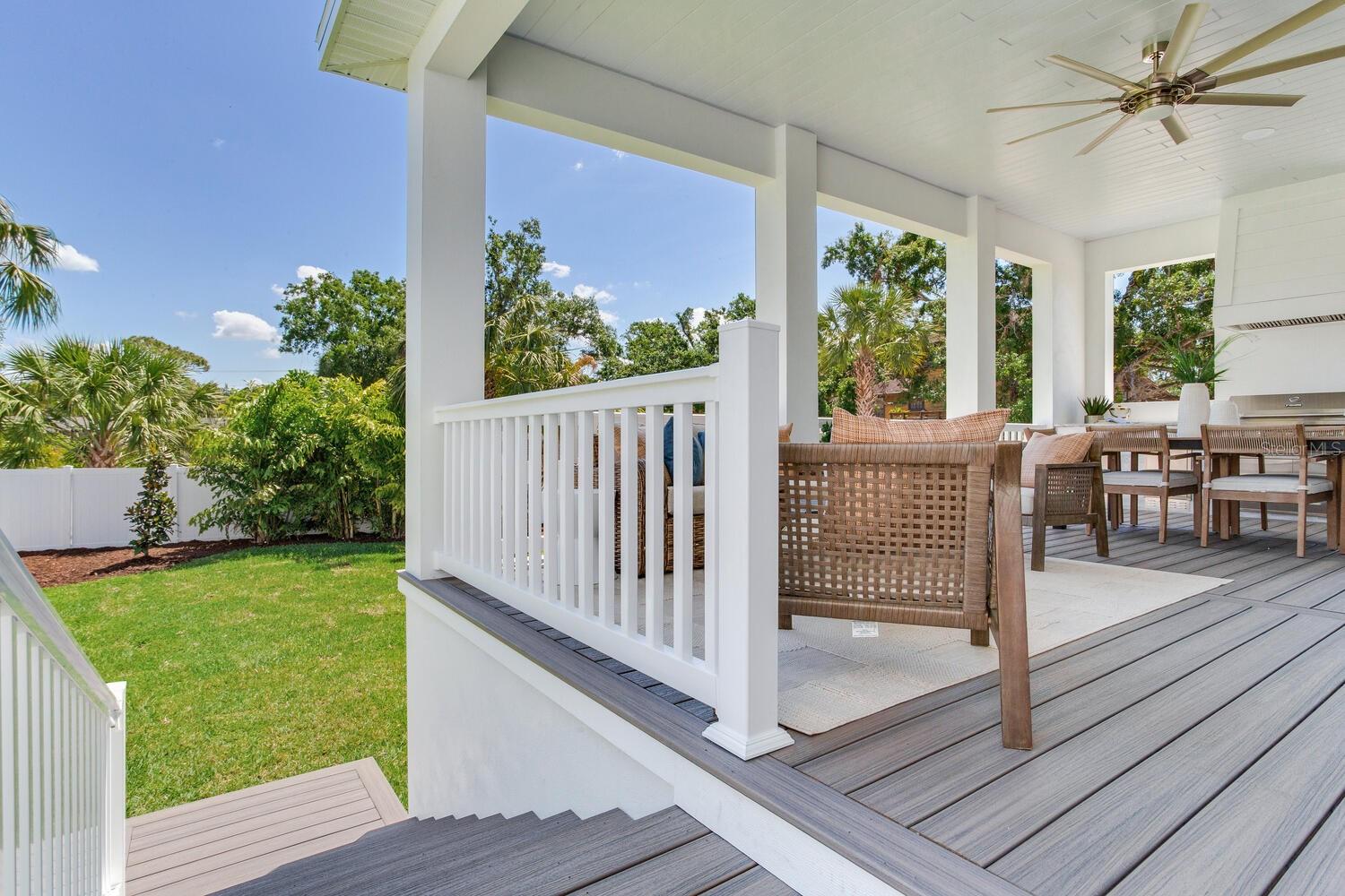 Composite decking and aluminum reinforced railing system lead to backyard