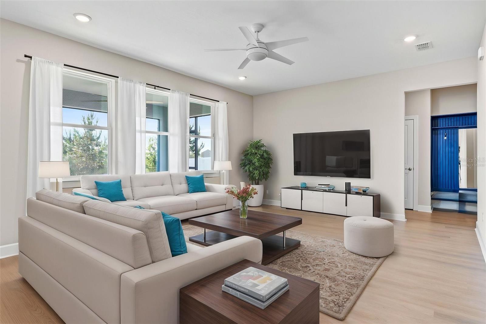Virtually staged living room/great room with access to the kitchen, dinette area, and 1st floor half bath.