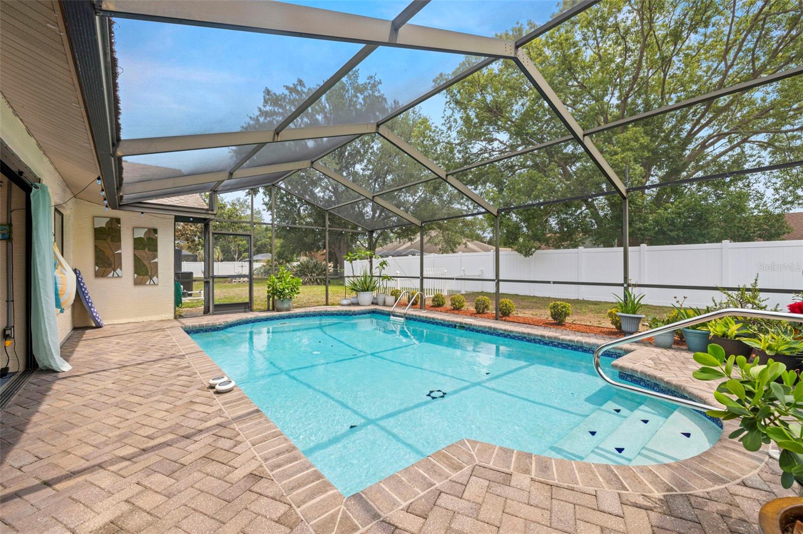 HEATED POOL!  Swim all year round in this private oasis!  Large screen enclosure, pavered pool deck, as well as access to the fenced in yard!