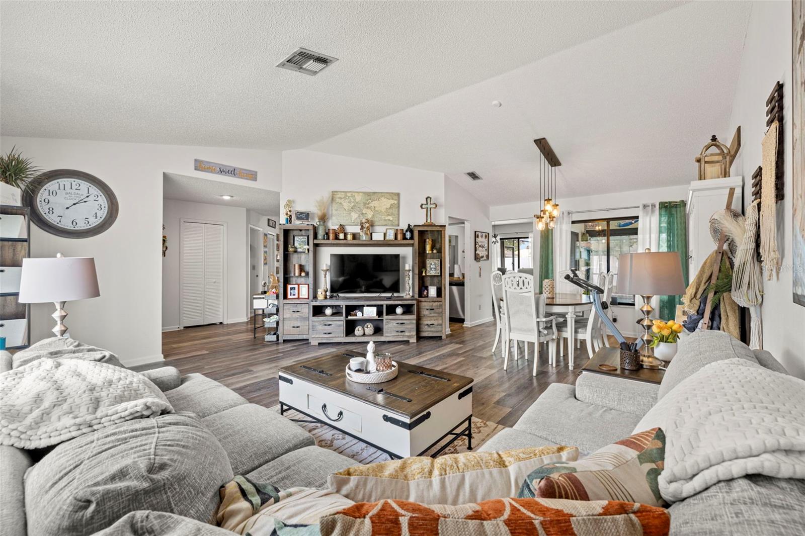 View of the Living room that is light, bright and roomy!  Plenty of room for that flat screen tv and loads of comfy seating for entertaining!