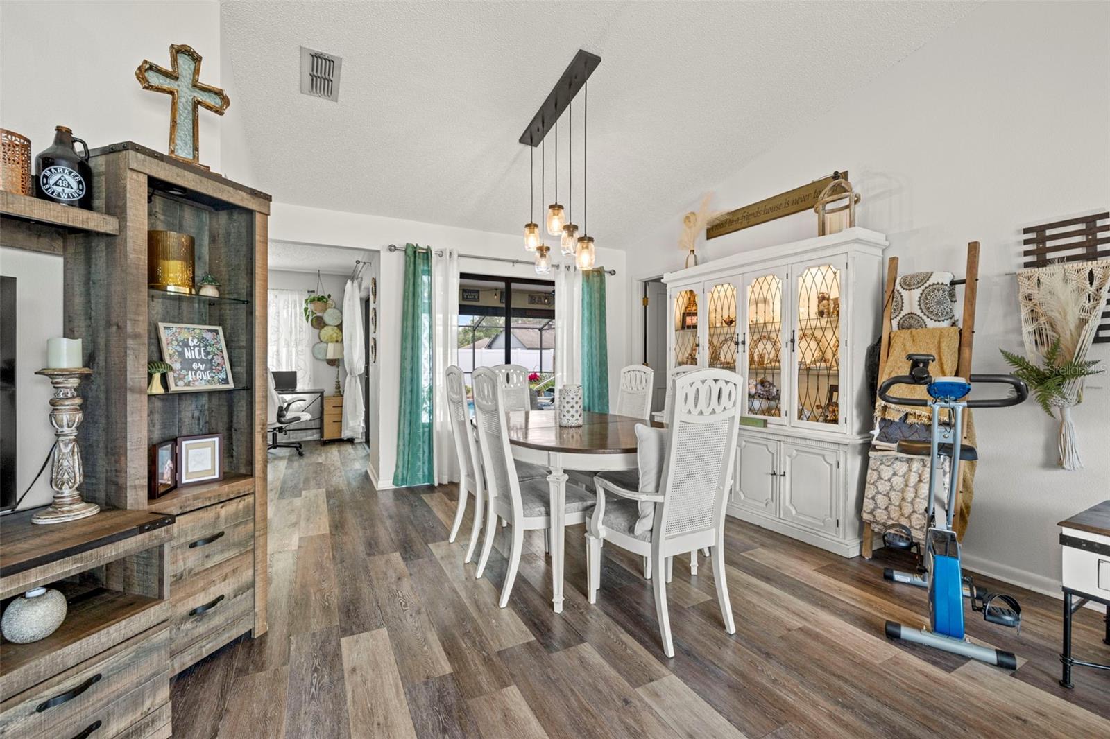 View of Dining room which looks over the screened in lanai & HEATED POOL!