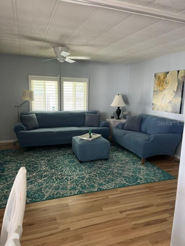 Spacious living room with plantation shutters on windows.