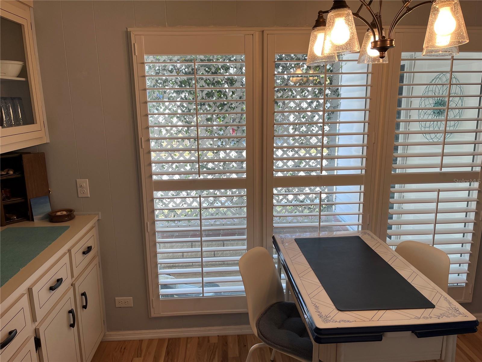 Dining room with Plantation shutters on windows.