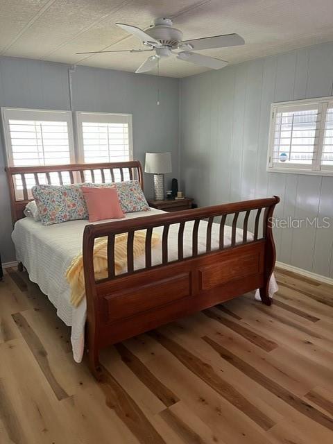 Master bedroom with newly installed waterproof vinyl plank flooring and plantation shutters.